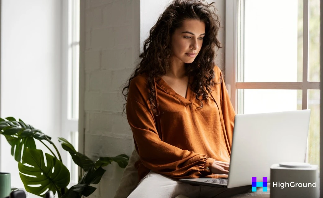 Medium shot woman working on laptop